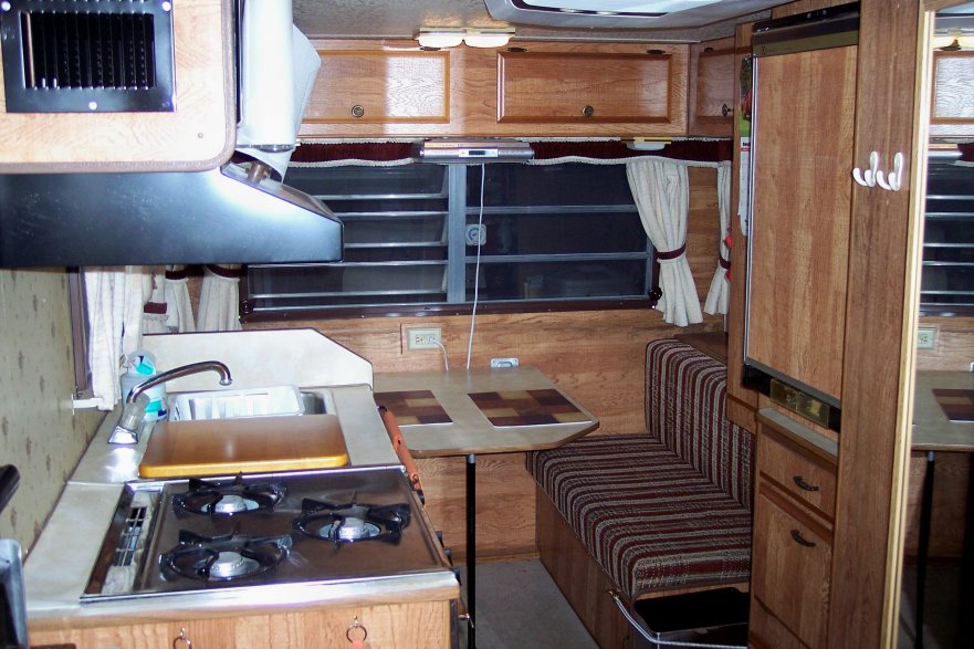 1984 Sunline F-1850 Fifth Wheel. Inside Rear View, showing kitchen & rear dinette, full length mirror on right is mounted on bathroom door.
100 9053