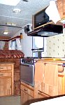 1984 Sunline F-1850 Fifth Wheel. Looking towards front from dinette area, showing kitchen, new installed microwave, stairs to sleeping loft. Above...
