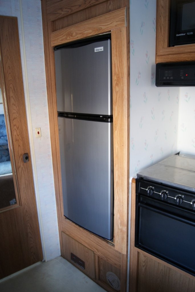 The owner replaced the Dometic with a simple 110 Magic Chef fridge