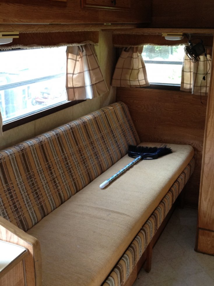 Couch folds out to a bed (raised bunk above has cabinet doors for storage use when in the upright position).