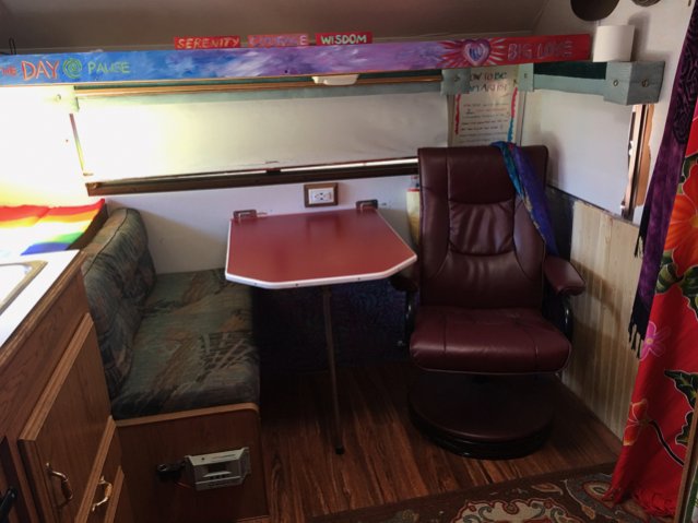 Always changing the dinette!  I make art and read at the dinette so I recently cut the table down to be able to stretch out in my lounger.  Next project: new cushions on the bench.  Can you see where I installed my charge controller and added a 9volt car adapter for my usb charging?
