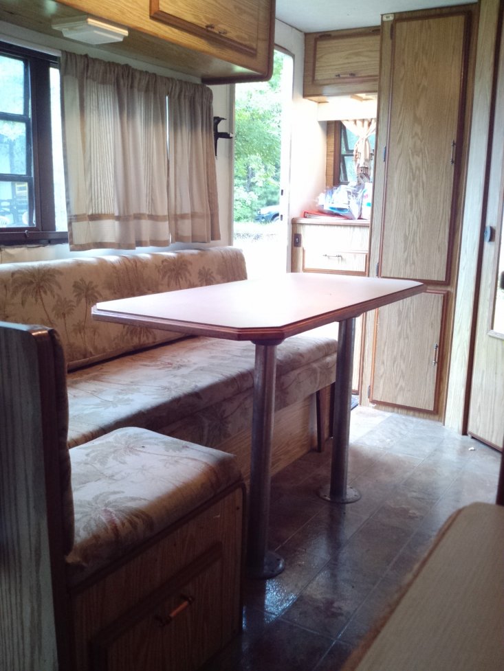 At front end of camper looking toward rear. Sofa/bed & removable table.