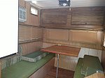 Area above table is fold down bunk. Pretty sure it is original. All the light paneling and pergo floor looks good but is hiding previous damage that...